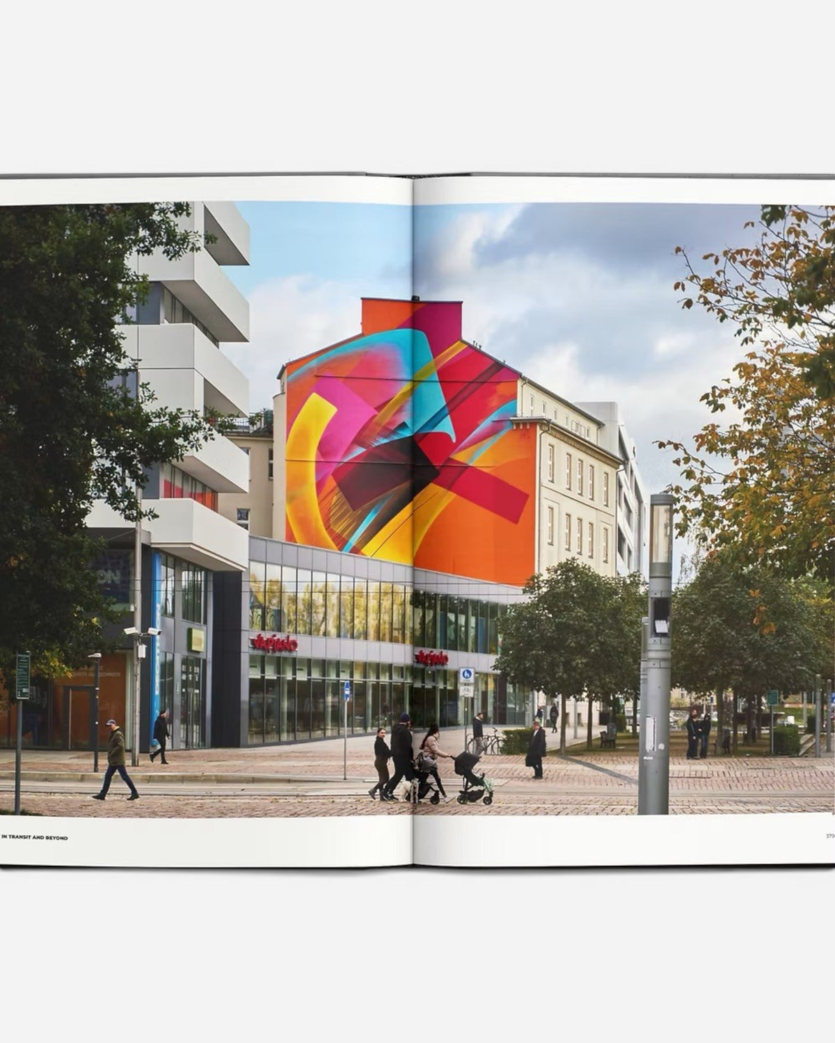 Astrofat Art In Transit And Beyond Hallenkunst book features a vibrant mural on a building facade, with people walking on the street below.