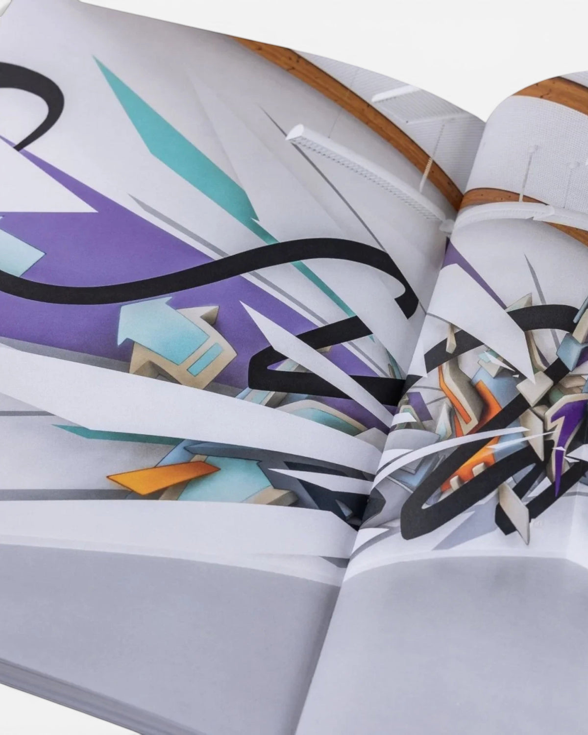 Astrofat DAIM Retrospective book open to a page showing complex 3D graffiti art with purple, blue, and black shapes.
