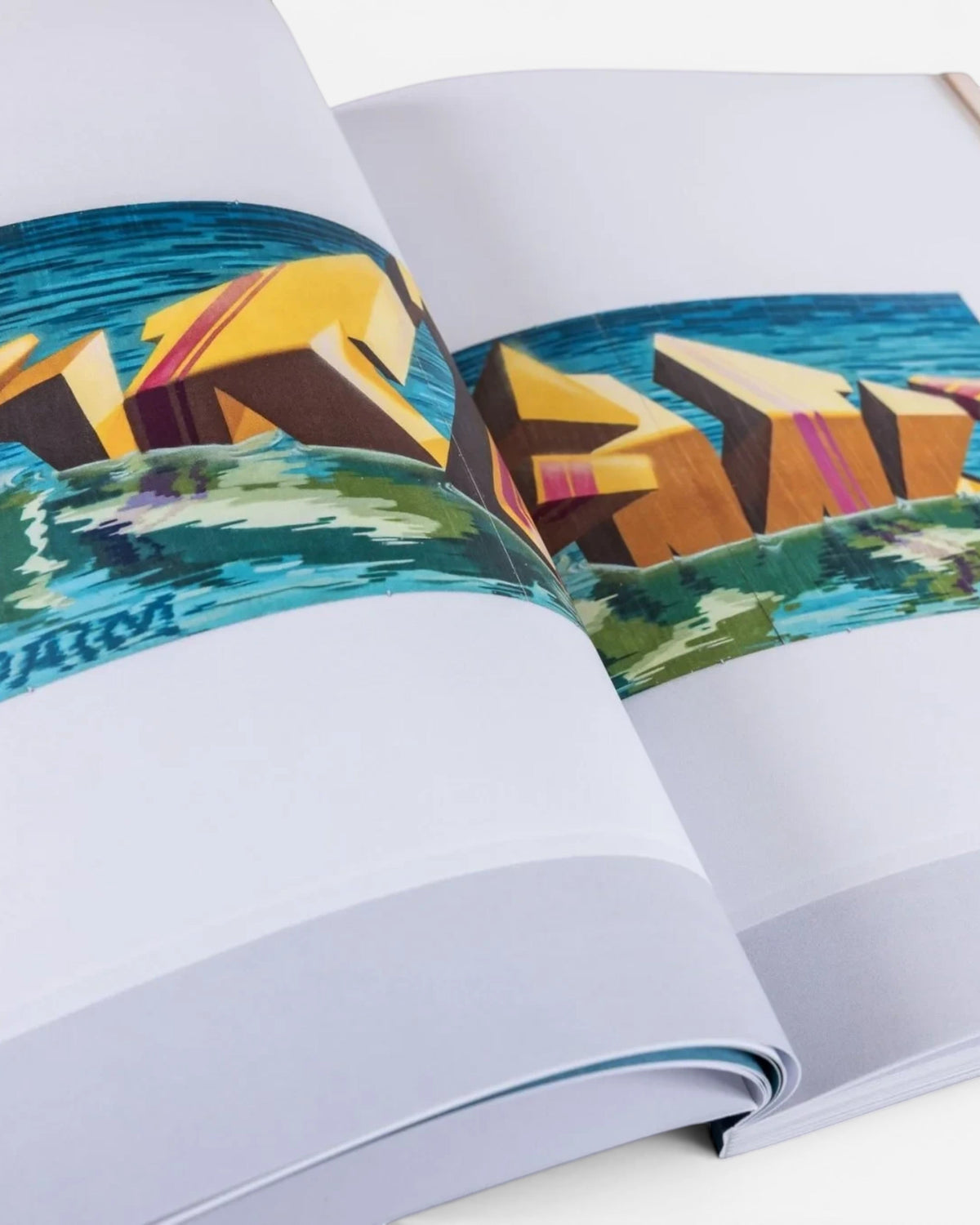 Astrofat DAIM Retrospective book open to a page showing 3D graffiti art with yellow and blue tones.