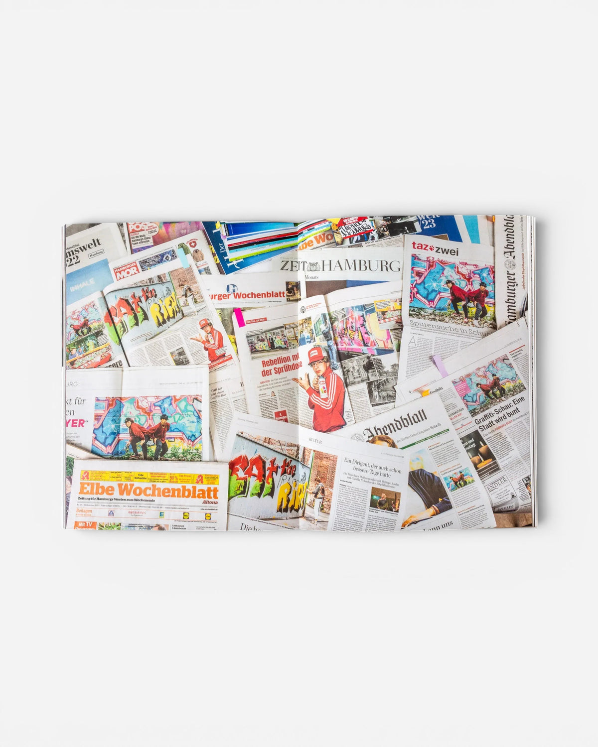 Astrofat EINE STADT WIRD BUNT. FLASHBACK book spread featuring a collage of Hamburg newspaper clippings on graffiti.