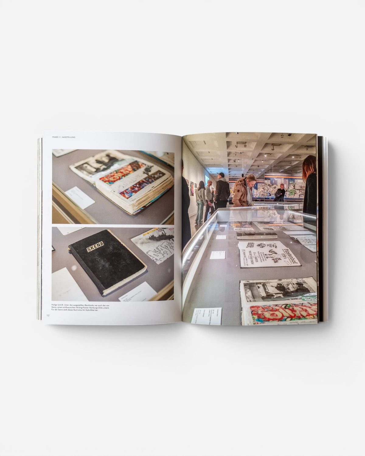 Open pages of Astrofat EINE STADT WIRD BUNT. FLASHBACK book showing graffiti exhibition photos and blackbooks.
