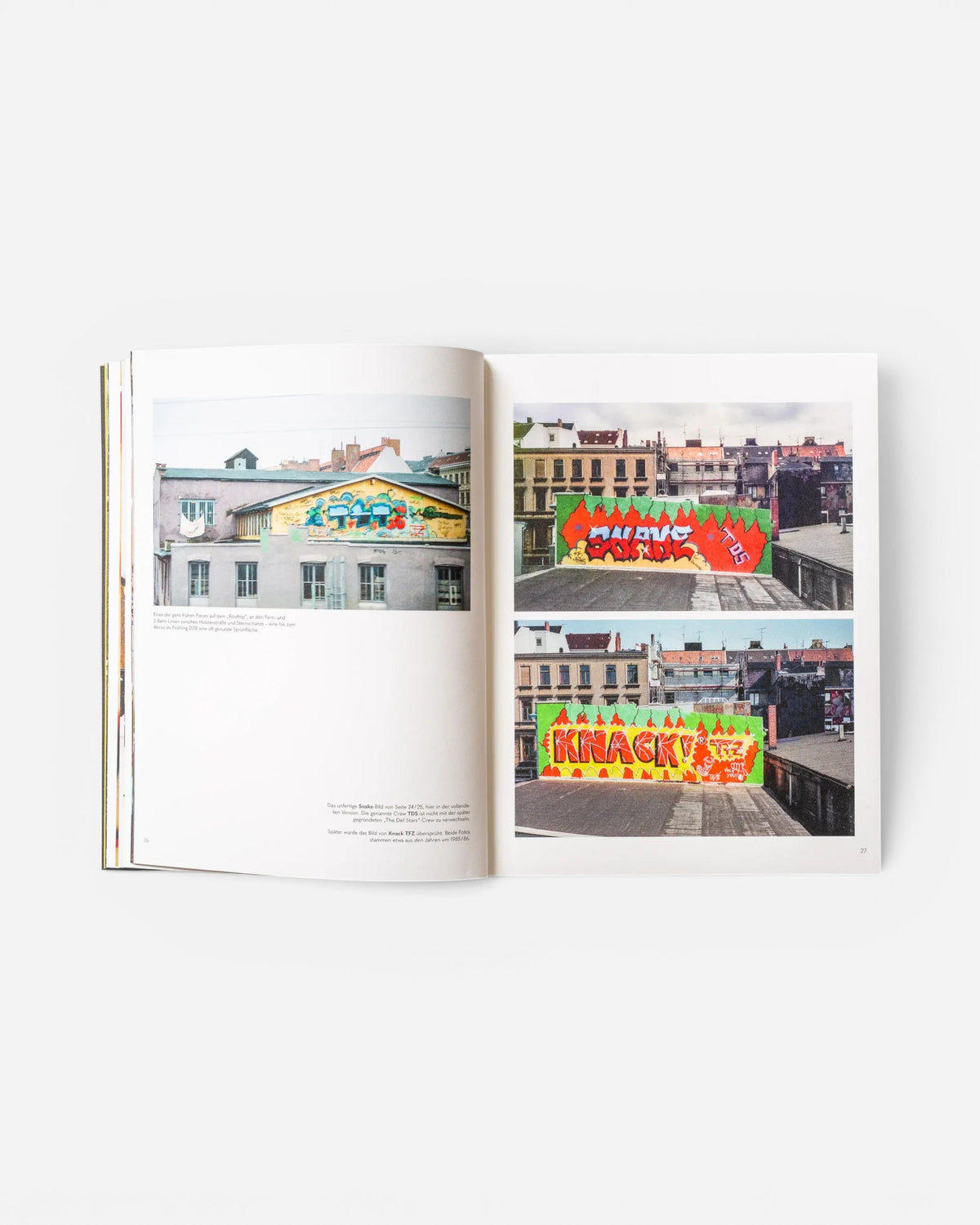 Astrofat EINE STADT WIRD BUNT. FLASHBACK book open to pages showing vintage graffiti rooftop murals in Hamburg.