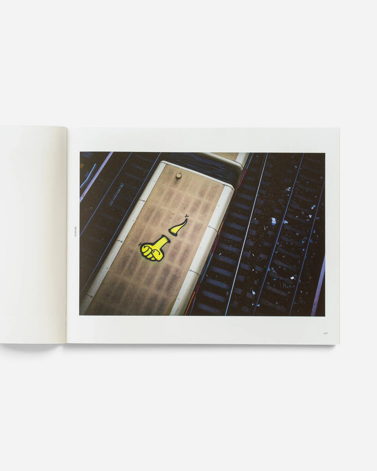 Astrofat Schriftzüge photobook open to a page showing an aerial view of a Berlin S-Bahn train with yellow graffiti
