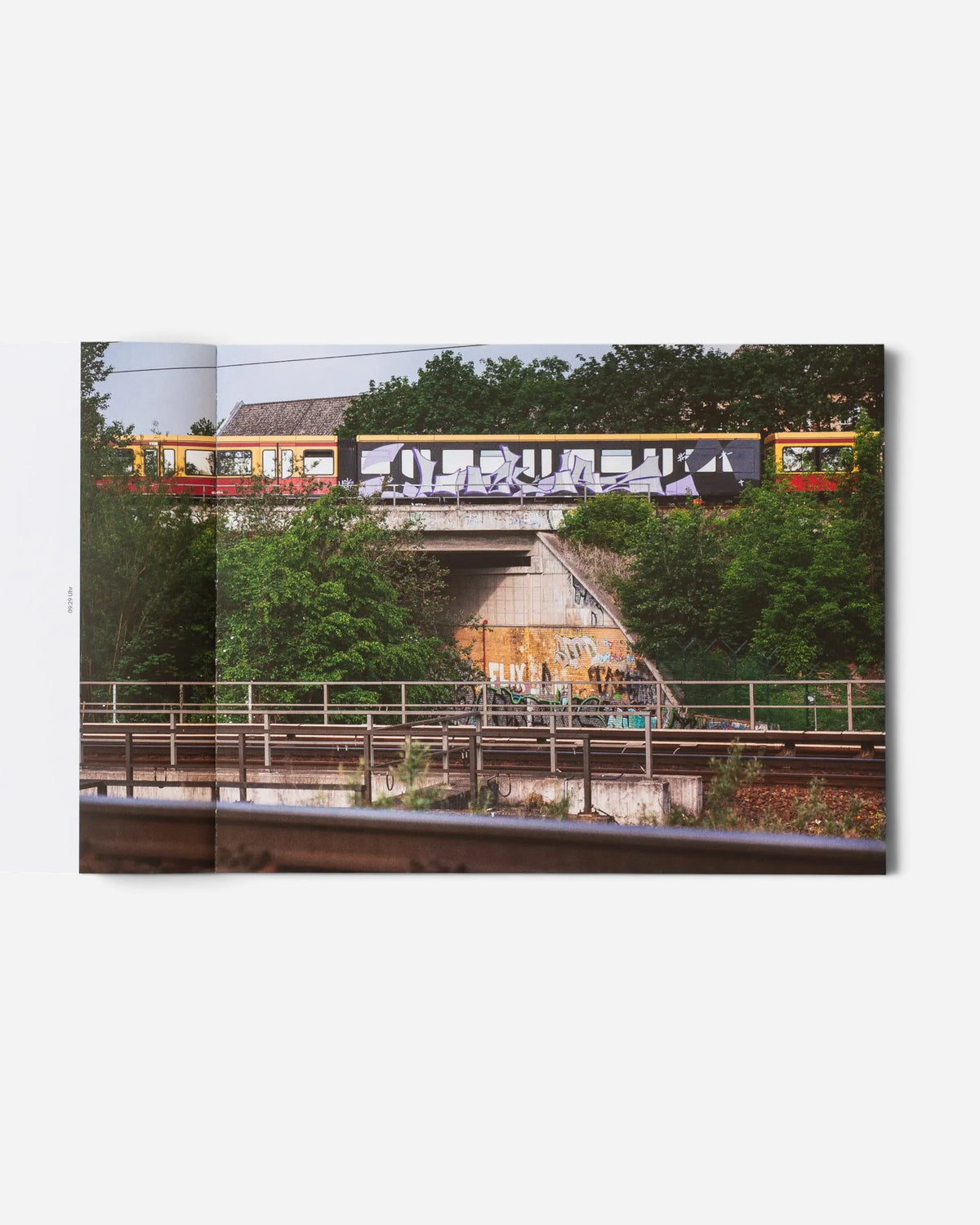A spread from the Astrofat photo book Schriftzüge showing a graffiti-covered Berlin S-Bahn train passing on a bridge.